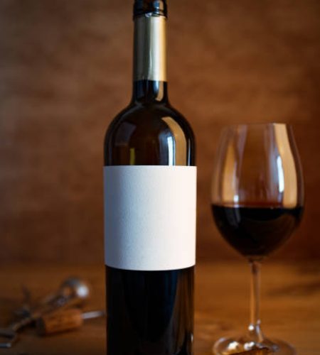 A bottle of wine on wooden table. Shallow focus.